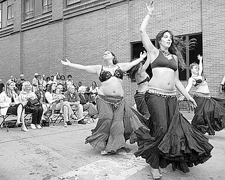 Dancers of Eos, Megan Thomas, Jennifer Neil, Katie Makita and Robyn DePaul perform a Romany American Tribal Style belly dance to "Yellow Rose Percussion" by Mezdeke during the Pig Iron Street Festival on Saturday afternoon.
