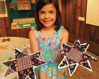 works of art - and proud of em - Ridley Clark 6 of youngstown displays her finished quilts peices that will be put together for a quilt - at the Mahoning Valley Historical Society's 'Pioneer Days' Summer Camp. Held at the Arms Family Museum in Youngstown - robertkyosay