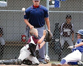 LITTLE LEAGUE - (8) Dylan Kurcov slides in safe as catcher Matt Perham can't come up with the ball and umpire Mike Calcagni looks on Sunday in Boardman. - Special to The Vindicator/Nick Mays