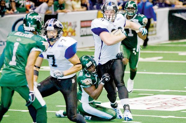 Mahoning Valley Thunder's Jon Loyte (99) drives down the field eventually being brought down by Green Bay Blizzard's Shadrack Okoebor (0) during the third quarter at the Covelli Centre on Saturday evening. Thunder's Jermaine Moye (7) and Blizzard's Tracy Belton (1) seen at left.