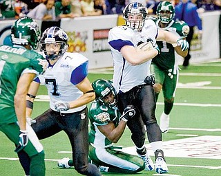 Mahoning Valley Thunder's Jon Loyte (99) drives down the field eventually being brought down by Green Bay Blizzard's Shadrack Okoebor (0) during the third quarter at the Covelli Centre on Saturday evening. Thunder's Jermaine Moye (7) and Blizzard's Tracy Belton (1) seen at left.