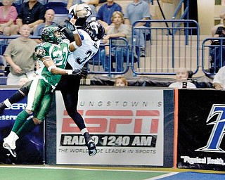 Mahoning Valley Thunder's Frashon McGee (37) catches a touchdown pass while being covered by Green Bay Blizzard's (21) during the fourth quarter at the Covelli Centre on Saturday evening. Thunder's Jermaine Moye (7) and Blizzard's Tracy Belton (1) seen at left.
