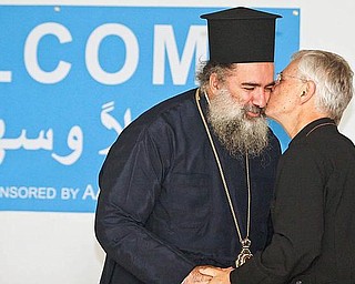 CALL FOR PEACE: Archbishop Theodosios (Atallah Hanna of Sebastia of the Greek Orthodox Diocese in Palestine, who visited the Arab American Community Center of Greater Youngstown Sunday, is welcomed by Father Dan Rohan of St. Mark Orthodox Church in Youngstown. Hanna said his message of one of hope for peace in the West Bank and Gaza through an end to Israeli occupation there.