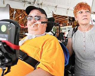 Several dozen motorcycle riders participated in a benefit run Sunday to raise money for a new home for Joe Kaluza, a former manager of a KFC restaurant on Youngstown&#8217;s South Side who was shot during a robbery last year and paralyzed. Kaluza, left, and his wife, Lisa, attended the start of the race at the Ice House Inn, Austintown.