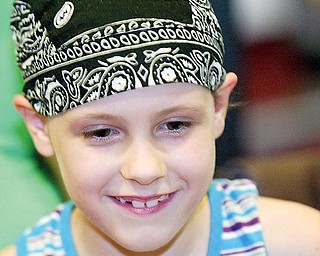 Below, Annie Harley likes to wears a bandana because her hair is still growing back after brain surgery.