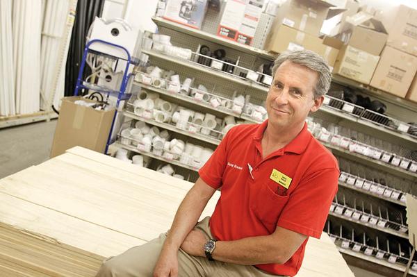 BACK TO WORK: Dave Bishop of Boardman sits among the hardware supplies at Busy Beaver in Salem. After months of unemployment, Bishop has been working as the store’s assistant manager for about a month.