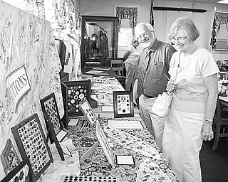 Special to The Vindicator
COLLECTIBLES: A collection of buttons fascinates Dean and Betty Brown of Poland as they get a sneak preview of exhibits to be displayed during Heritage Day on Sunday at the Ward-Thomas Museum in Niles.