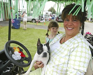 ROCKY - a Boston Terrier with her owner Gwen Weyandt and daughter Janee age 6.. on their decorated golf cart.. talk about the dog show and showing - the four day Steel Valley Cluster Dog Show at the Canfield Fairgrounds runs through Sunday - robertkyosay