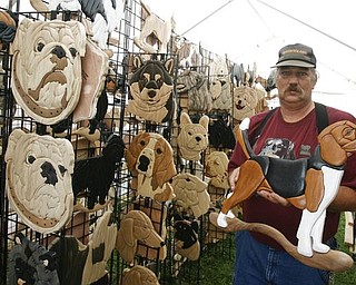 MYINTARSIA - Rich Morrison of Mt . Gilead Ohio has his intarsia ( wood inlaid) dog sculptures - -as the four day Steel Valley Cluster Dog Show at the Canfield Fairgrounds runs through Sunday - robertkyosay