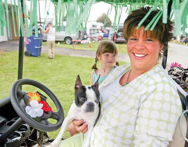ROCKY -  a Boston Terrier with her owner  Gwen Weyandt and daughter Janee age 6.. on their decorated golf cart.. talk about the dog show and showing - the four day Steel Valley Cluster Dog Show at the Canfield Fairgrounds runs through Sunday - robertkyosay