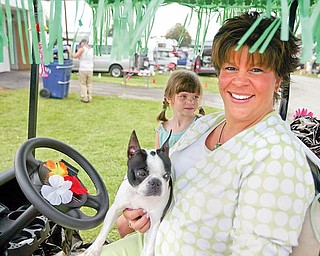 ROCKY - a Boston Terrier with her owner Gwen Weyandt and daughter Janee age 6.. on their decorated golf cart.. talk about the dog show and showing - the four day Steel Valley Cluster Dog Show at the Canfield Fairgrounds runs through Sunday - robertkyosay
