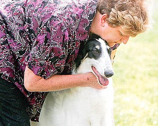 Edna Hanley, of Columbiana, embraces Zoey, a Borzoi, who competed in the Best of Show category of the Steel Valley Cluster Dog Show. The four-day show is at the Canfield Fairgrounds and runs through Sunday.