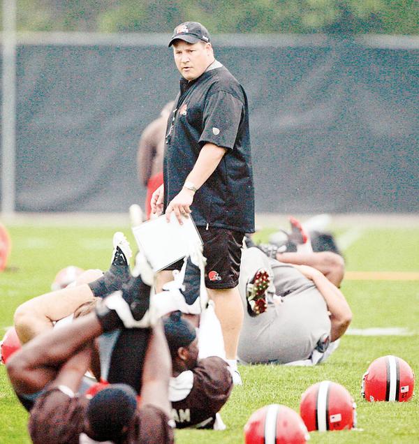Cleveland Browns head coach Eric Mangini  looks on a players stretch during football minicamp at the Browns training facility, Thursday, June 11, 2009, in Berea, Ohio. 