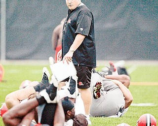 Cleveland Browns head coach Eric Mangini looks on a players stretch during football minicamp at the Browns training facility, Thursday, June 11, 2009, in Berea, Ohio.