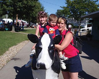 Maddie and Andrew Moran are with their mom, Jill, and their favorite cow at the Canfield Fair.