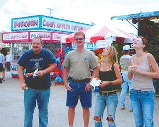 Enjoying a past Canfield Fair are, from left, Brian Tibolla of Raleigh, N.C., formerly of Boardman; Jeffrey Johnson of Poland; and Jeffrey's daughters, Jamie Corvino and Necole Tibolla, both of Raleigh and formerly of Poland.