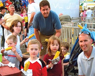 The Sweder family, enjoying corn on the cob at St. Nick's Festival in Struthers, includes Jeff and Christie of Poland with their three sons, Ryan, Jason and Evan of Poland, and Michael and his daughter, Riley, of Columbus.