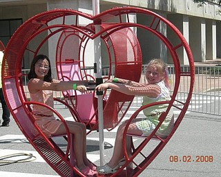Sarah McKim, left, and Alyssa Metzler, both of New Middletown, having fun on the rides at the Greater Youngstown Italian Fest.