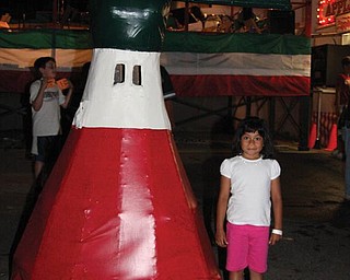 Kate Coppola poses with the baby doll at the Lowellville Mount Carmel Festival on July 15.