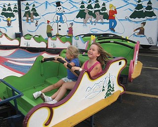 Julianna and Madison Hornikel enjoy this ride at St. Luke's Festival.