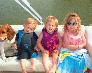 Hadyn and Kaelyn Bower, both 2, and big sister Brelyn, 4, enjoy a boat ride with the family dog, Trinity. They are the children of Brandon and Jackie Bower of Austintown.
