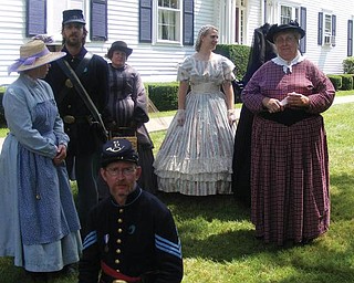 The women of the 61st OVI Company D are getting ready for a fashion show to exhibit dresses of the 1800's (taken by Kayla Windsor).