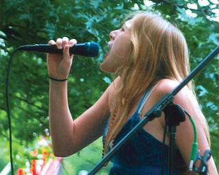 Leanna Hartsough, 16, of Canfield High School performs in the American Idol contest during the Fourth of July festivities in Canfield.