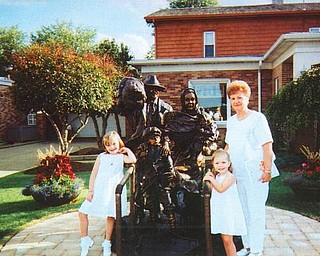 Great-grandma Virginia Gentile stands at the immigrant statue with Mia and Giana Spera of Boardman when they attended the Our Lady of Mount Carmel Festival.