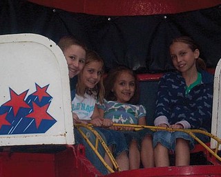 From left are cousins Aaron Gault of Youngstown, Chloe Parker of Charlotte, N.C., Karlynn Riccitelli of Boardman and Quinn Parker of Charlotte as they enjoy riding the Til-a-Whirle together at the McDonald Festival.