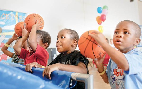 AIMING HIGH: Terrell Vaughn and Kendail Clark, both 4 and preschoolers at the Center for Community Empowerment, show their basketball skills. The weekend reunion for current and former residents of Rockford Village, formerly Kimmel Brook, will be filled with a list of activities for adults and children.  