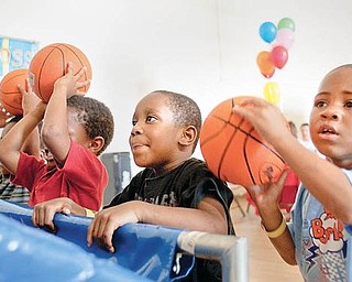 AIMING HIGH: Terrell Vaughn and Kendail Clark, both 4 and preschoolers at the Center for Community Empowerment, show their basketball skills. The weekend reunion for current and former residents of Rockford Village, formerly Kimmel Brook, will be filled with a list of activities for adults and children.  