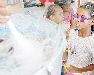COTTON CANDY: KeyAsia Thompson eyes the cotton candy being spun during the weekend reunion at Rockford Village, formerly called Kimmel Brook. The idea started as a 10-year celebration for the Center for Community Empowerment but quickly grew to include an overall Kimmel Brook celebration.  