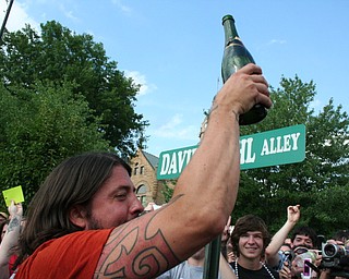 Dave Grohl celebrates with champagne at the David Grohl Alley dedication ceremony in Warren.