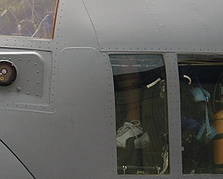 GHOST FLIGHT: Pavlik and daughter, Sydney, 4, peek out of the cockpit of the C-130. The artwork was unveiled at the base Tuesday.