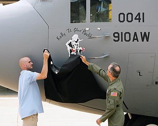 NOSE JOB: World middleweight boxing champion Kelly “The Ghost” Pavlik and Col. Karl McGregor unveil Pavlik’s logo on the nose of a C-130 Hercules cargo transport plane at the Youngstown Air Reserve Station. The artwork was done by Michele Kennedy of Warren, who has been in the Air Force Reserve for about four years.