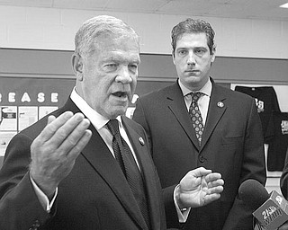 PROMOTING REFORM: U.S. Rep. Charlie Wilson of St. Clairsville, D-6th, left, advocates health-care reform during an impromptu news conference Tuesday in Youngstown. Joining him is U.S. Rep. Tim Ryan of Niles, D-17th.