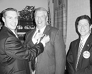 Special to The Vindicator
FAMILY PLAN: During the July 27 meeting of the Rotary Club of Austintown, from left, Brian Laraway, club president, had the honor of placing a Rotary pin on the lapel of his father, Bruce Laraway who is employed in sales at Advanced Feedscrews in New Castle, Pa.  As members of one of the largest service organizations in the world, the two will work together to help the club on the local and international levels. Attending the presentation is Dr. Mitch Dalvin.  
                               