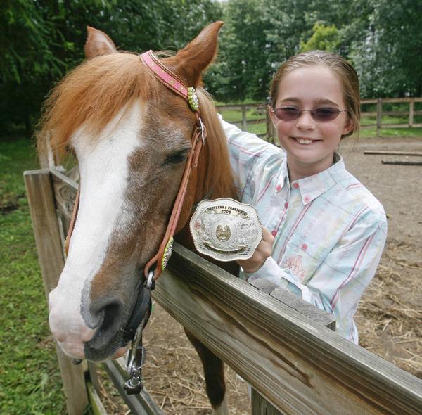 Madelynn Felgar with her Championship trophy  belt buckle  - robertkyosay