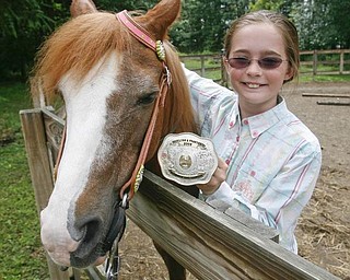 Madelynn Felgar with her Championship trophy belt buckle - robertkyosay