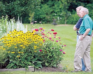 Jack Fergus, left, and his father, John Fergus, both of Canfield, look at the gardens during the "Connecting with Yourself, Nature and the Creator" event in Canfield on Sarturday.