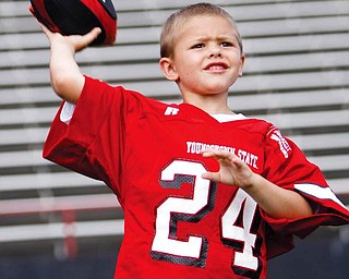 Jake Wright, wearing the famed #24 of YSU, tosses a few passes for his dad, Offensive Coach Brian Wright at football photo day at YSU.