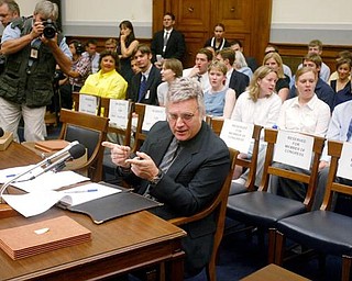 Empty chairs for members of Congress and prospective witnesses are seen behind Rep. James Traficant, D-Ohio, on Capitol Hill in Washington, Monday, July 15, 2002 prior to a House Ethics Committee hearing. Traficant told a House ethics panel considering whether he should be expelled from the House that he was innocent of the fraud, bribery and tax evasion that a jury convicted him of, and that he is being persecuted by the Justice Department.