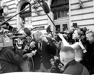 Jim Traficant ducks under media cables while leaving federal court April 4, 2002, after being found guilty.