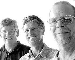THEY WERE THERE: From left, Bruce Neff of Canfield, Jim McCreary, a Canfield native now living in Bonita Springs, Fla, and Jeff Enterline, a Canfield Native now living in Austintown, reminisce about Woodstock. The trio attended the concert bash 40 years ago when they were 20 years old.