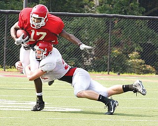 YSU WR Dionte Snow can't break away from safety Scott Sentner during Saturday's scrimmage at Stambaugh Stadium. Sentner is a McDonald high graduate.