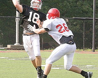 TOUGH THROW: YSU QB Dailyn Campbell tries to complete a pass as linebacker David Rach applies pressure during Saturday's scrimmage. Rach is a South Range High graduate.