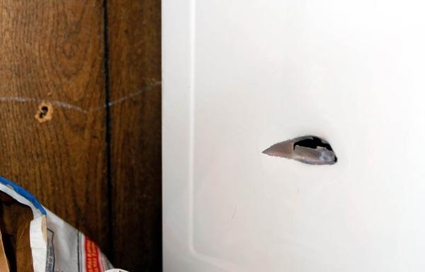 SMALL HOLE, BIG REMINDER: A hole in a dryer is a grim reminder of the violence that takes place outside the Francis Humphries East Side home and often spills over into the family home. Humphries says he is tired of the gunfire and noise around his home in the late-night hours.