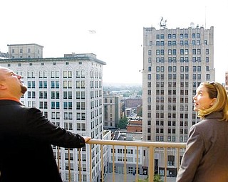 Troy Miglets, of Austintown, looks up at the Realty Building from a balcony on the 11th floor, alongside Shanna Sallmen,  Development officer with ysu and resident of new castle. "I just wanted to see the complex, see how they've progressed, its absolutely beautiful," said Sallmen.