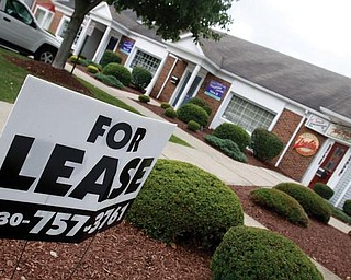SIGNS OF THE TIMES: The economic downturn has made it more difficult to find tenants for retail property, such as this building at McKinley Way and Main Street in Poland.