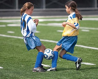 The Vindicator/Geoffrey Hauschild
A soccer ball gets stuck as Justine Kramer challenges Jillian Penman for the ball during a game at Poland High School.
8.15.2009